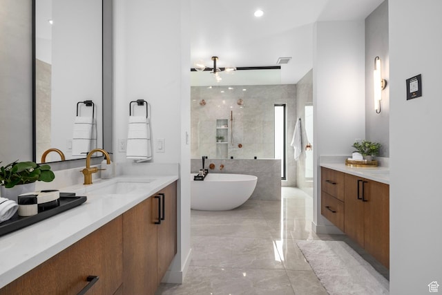 full bath with visible vents, a freestanding tub, a walk in shower, vanity, and marble finish floor