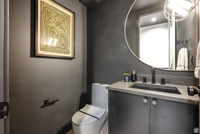 half bath featuring toilet and vanity