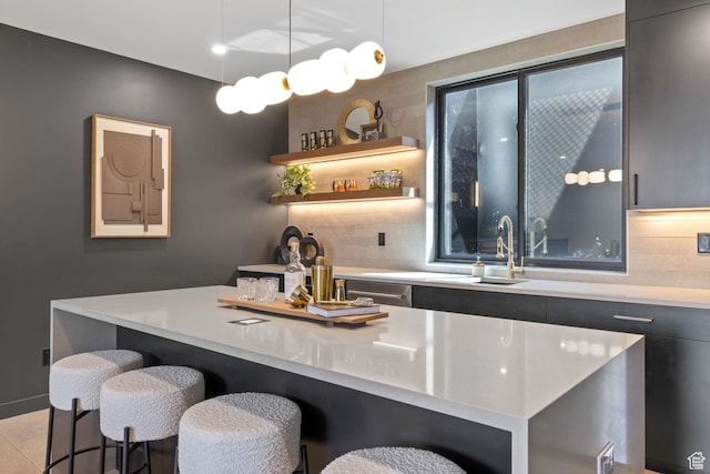 bar featuring a sink, backsplash, pendant lighting, and wet bar