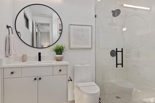 full bath featuring vanity, visible vents, a stall shower, and toilet