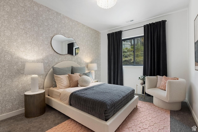 carpeted bedroom featuring wallpapered walls and baseboards