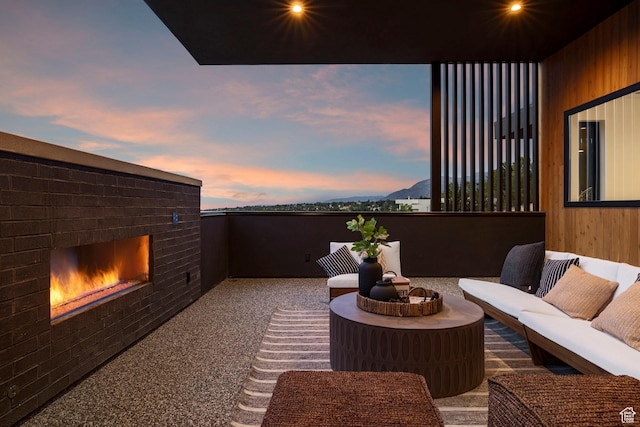 view of patio / terrace featuring a mountain view and an outdoor living space with a fireplace