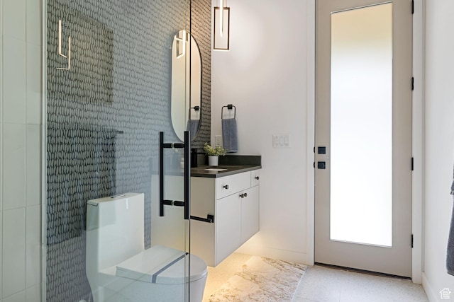 bathroom with elevator, toilet, a walk in shower, and vanity