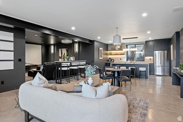 living area featuring indoor wet bar, finished concrete flooring, visible vents, and recessed lighting