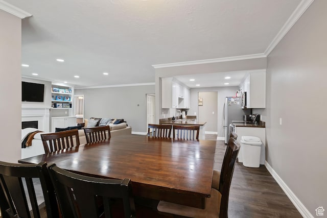 dining room with ornamental molding, baseboards, and dark wood finished floors