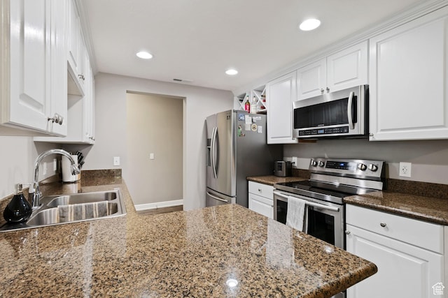 kitchen with recessed lighting, white cabinetry, visible vents, appliances with stainless steel finishes, and a sink
