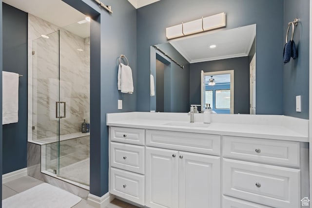 bathroom featuring vanity, baseboards, ornamental molding, a marble finish shower, and ceiling fan