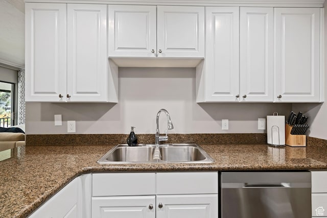 kitchen with stainless steel dishwasher, white cabinetry, and a sink