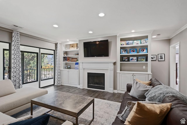 living area featuring recessed lighting, a fireplace, ornamental molding, and dark wood finished floors