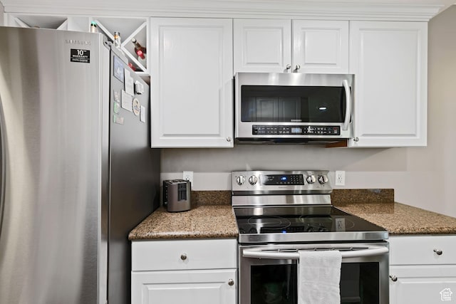 kitchen with white cabinets and appliances with stainless steel finishes