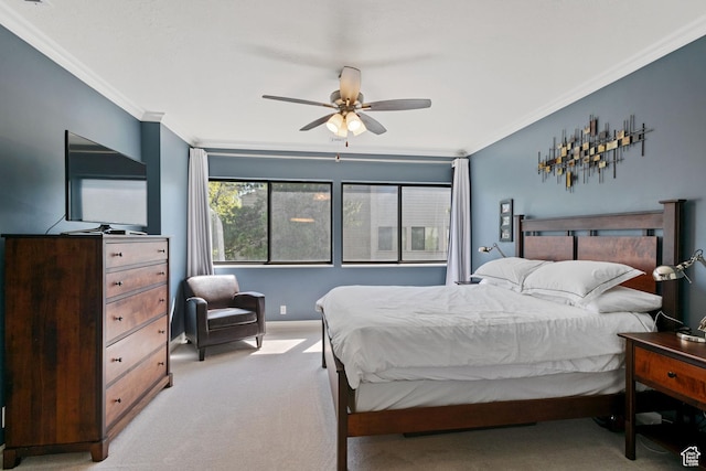 bedroom featuring light colored carpet, ornamental molding, and a ceiling fan