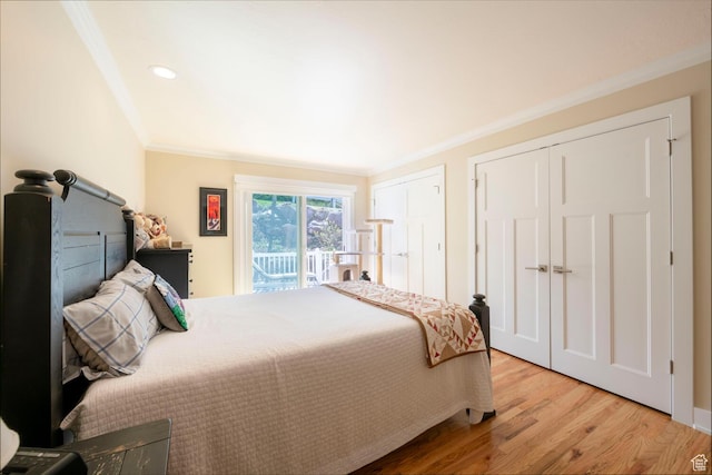 1960 S High Pointe St E Unit 22, Bountiful, UT 84010 - bedroom featuring ornamental molding, multiple closets, access to outside, and wood finished floors