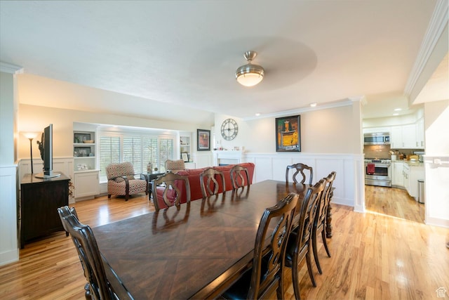 1960 S High Pointe St E Unit 22, Bountiful, UT 84010 - dining space with light wood-style flooring, wainscoting, a decorative wall, and ornamental molding