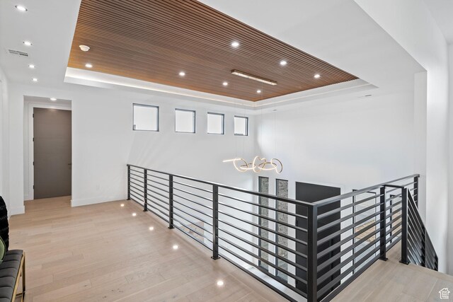 1582 S Wiltshire Ln, Saratoga Springs, UT 84045 - hall with visible vents, an upstairs landing, a tray ceiling, recessed lighting, and wood finished floors