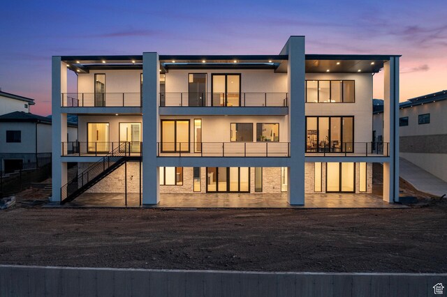 1582 S Wiltshire Ln, Saratoga Springs, UT 84045 - back of property at dusk featuring stucco siding