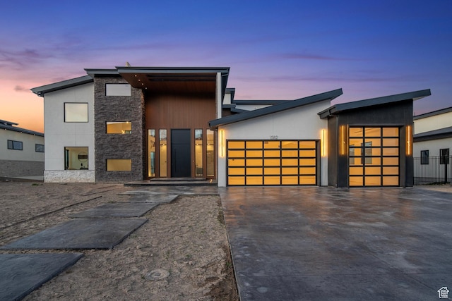 1582 S Wiltshire Ln, Saratoga Springs, UT 84045 - contemporary house with stone siding, a garage, and concrete driveway