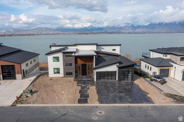 1582 S Wiltshire Ln, Saratoga Springs, UT 84045 - view of front of house with driveway, stucco siding, stone siding, and a water and mountain view