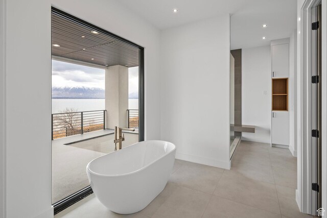 1582 S Wiltshire Ln, Saratoga Springs, UT 84045 - full bathroom featuring a water view, baseboards, recessed lighting, tile patterned flooring, and a freestanding bath