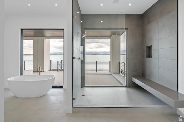 1582 S Wiltshire Ln, Saratoga Springs, UT 84045 - full bathroom with a soaking tub, recessed lighting, tile patterned floors, walk in shower, and tile walls