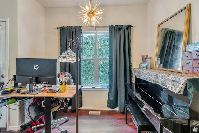 office space with visible vents, baseboards, an inviting chandelier, and wood finished floors