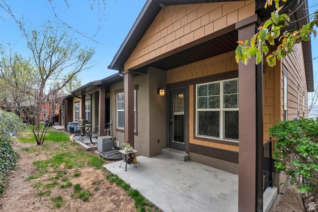 entrance to property with a patio area and stucco siding
