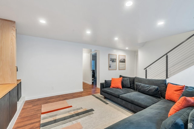 living room featuring recessed lighting, baseboards, and wood finished floors