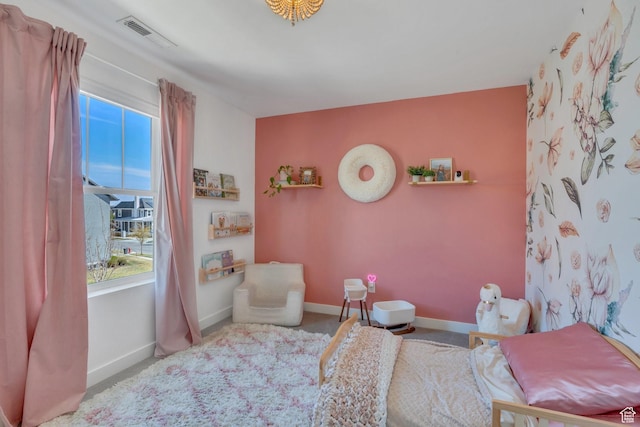 bedroom featuring visible vents, baseboards, and carpet