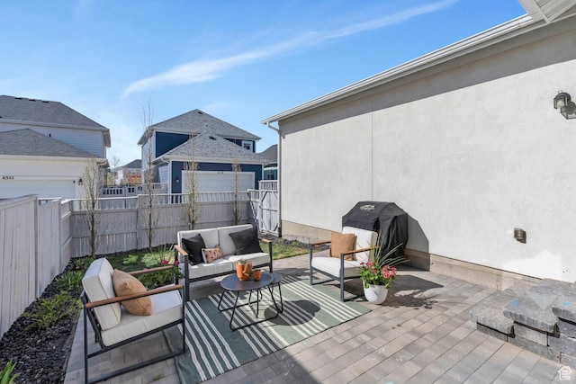 view of patio with an outdoor living space, a grill, and fence