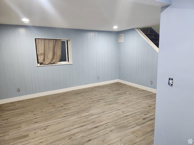 finished below grade area with wood finished floors, baseboards, and recessed lighting