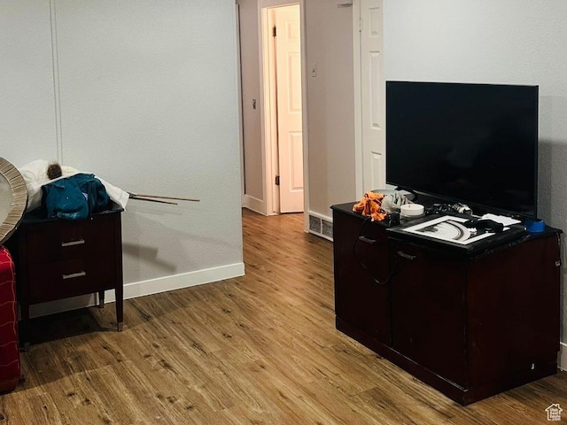 interior space with baseboards and wood finished floors