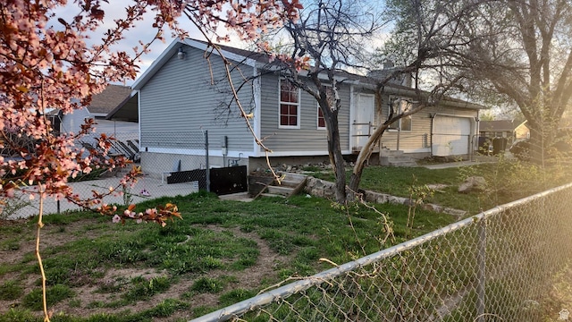 view of home's exterior featuring a garage, entry steps, and fence