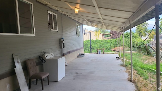 view of patio featuring washer / clothes dryer and fence