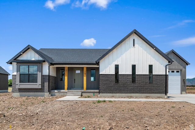 1489 E 820 N Unit 104, Salem, UT 84653 - modern farmhouse featuring board and batten siding, a porch, brick siding, an attached garage, and concrete driveway