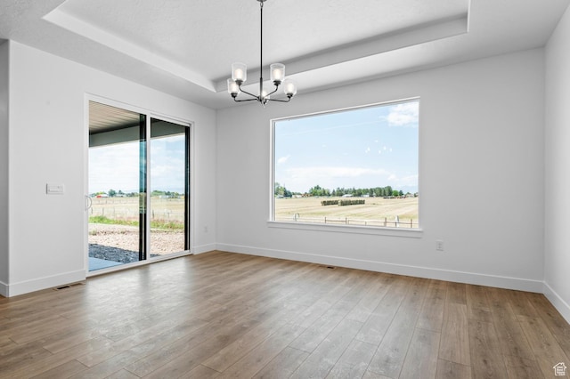 1489 E 820 N Unit 104, Salem, UT 84653 - spare room with a tray ceiling, a chandelier, and hardwood / wood-style floors