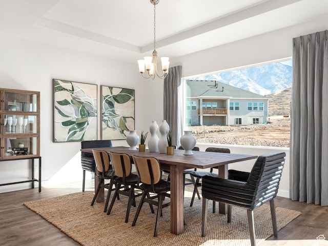 dining space featuring wood finished floors and a notable chandelier