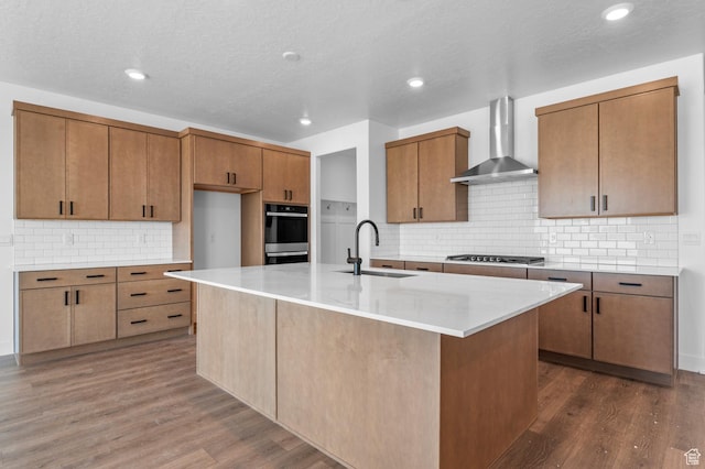 1489 E 820 N Unit 104, Salem, UT 84653 - kitchen featuring wall chimney exhaust hood, stainless steel gas cooktop, dark wood finished floors, tasteful backsplash, and recessed lighting