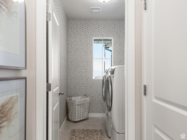laundry room with light tile patterned floors, washing machine and dryer, laundry area, and visible vents