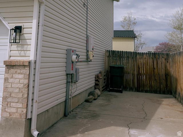 view of property exterior featuring a patio area and fence
