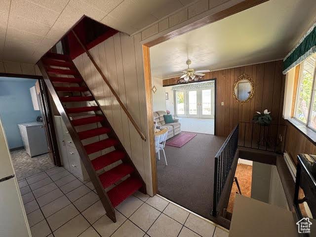 1640 S Bear Lake Blvd, Garden City, UT 84028 - carpeted entryway with plenty of natural light, a ceiling fan, stairway, tile patterned flooring, and wooden walls