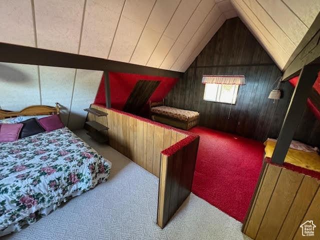 1640 S Bear Lake Blvd, Garden City, UT 84028 - carpeted bedroom featuring wood walls and lofted ceiling