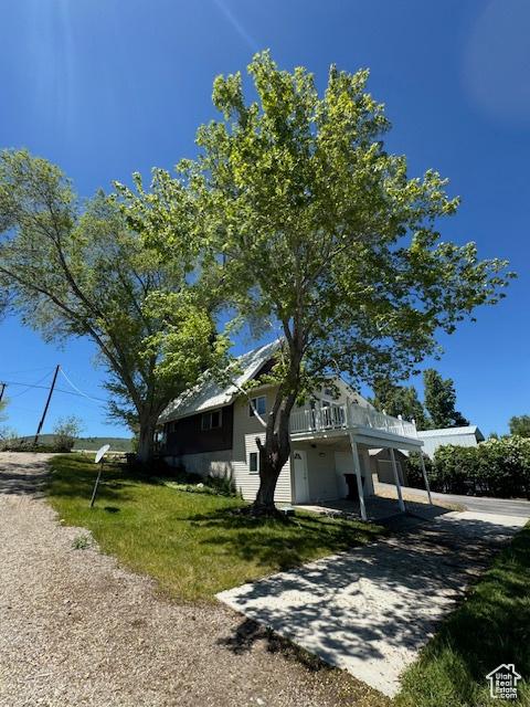 1640 S Bear Lake Blvd, Garden City, UT 84028 - view of side of home featuring a wooden deck and a lawn