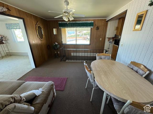 1640 S Bear Lake Blvd, Garden City, UT 84028 - carpeted dining space featuring plenty of natural light, ceiling fan, wood walls, and a baseboard heating unit