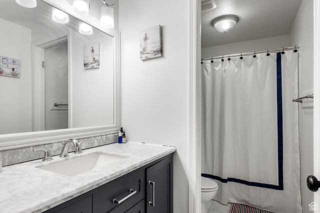 bathroom with vanity, marble finish floor, a shower with curtain, and toilet