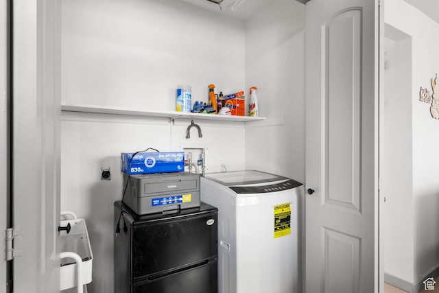 washroom with independent washer and dryer and laundry area