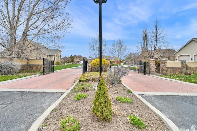 1141 S Waterside Dr, Saratoga Springs, UT 84045 - view of street with curbs, a residential view, a gated entry, and a gate