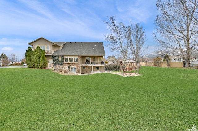 1141 S Waterside Dr, Saratoga Springs, UT 84045 - rear view of house featuring stucco siding, fence, and a lawn