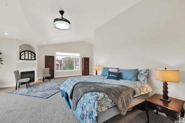 1141 S Waterside Dr, Saratoga Springs, UT 84045 - carpeted bedroom featuring baseboards, a glass covered fireplace, and vaulted ceiling