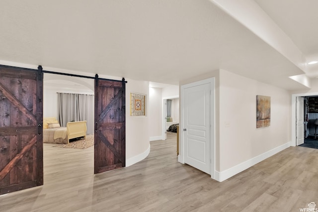 1141 S Waterside Dr, Saratoga Springs, UT 84045 - corridor featuring baseboards, light wood finished floors, and a barn door