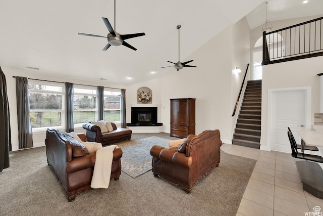 1141 S Waterside Dr, Saratoga Springs, UT 84045 - living area with baseboards, stairway, light tile patterned floors, a ceiling fan, and high vaulted ceiling