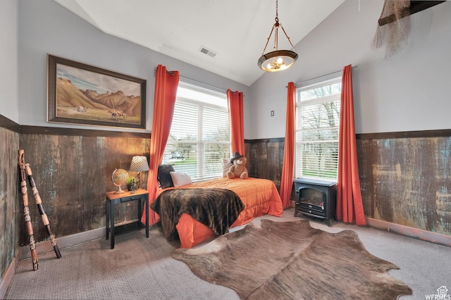 1141 S Waterside Dr, Saratoga Springs, UT 84045 - bedroom featuring carpet flooring, wooden walls, wainscoting, visible vents, and lofted ceiling
